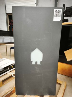 a picture of a piece of metal with a house sticker on it