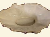 a white bowl with a gold rim on a white background