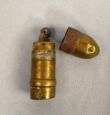 a close up of a bullet and a bullet on a white surface