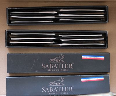 four different types of sabers in a box on a table