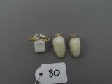 three pairs of rings and a ring on a table with a price tag