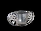 a glass cup with a handle on a black background