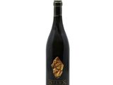 a bottle of wine sitting on top of a white surface