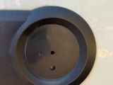 a close up of a car ' s door handle with a small hole in it