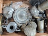 a cardboard box full of old silver pots and pans