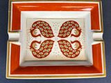 an orange and white plate with a butterfly design on it