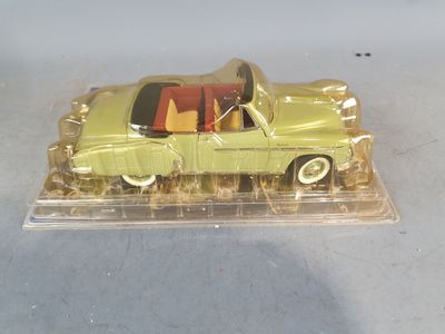 a yellow toy car in a clear plastic box