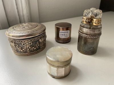 three different types of silver items on a white table