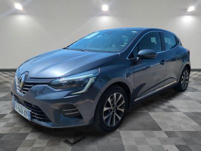 a grey car is parked in a room with a checkered floor