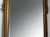 a mirror hanging on the wall above a sink