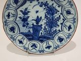 une image représentant une assiette bleue et blanche ornée d'oiseaux et de fleurs