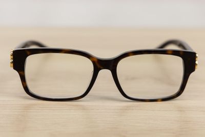 glasses on a wooden table with a white wall in the background