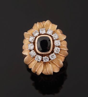 a close up of a ring with a black stone surrounded by white diamonds