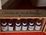 a wooden box filled with bottles of wine on a table