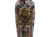 a vase that has a picture of flowers on it