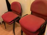 two red chairs in the corner of a room