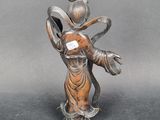 statue of a woman holding a bird on her head