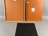 an open box with a piece of cardboard and a piece of black paper