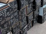 many boxes of electronic devices stacked on top of each other