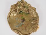 a gold plate with a bunch of flowers on it