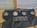 four lights that are sitting on top of a black bag