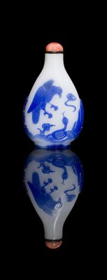 a blue and white vase with a picture of a man on it