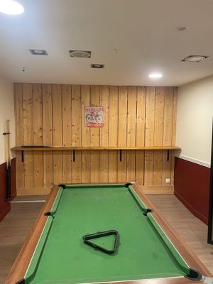 a pool table in the middle of the room