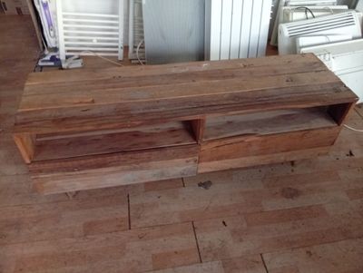 a wooden table with two drawers on top of it