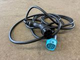a close up of a blue and black power cord on the ground