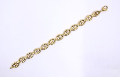 a close up of a gold bracelet on a white background