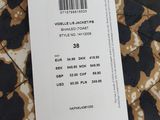 the label on the back of a black and white leopard print jacket