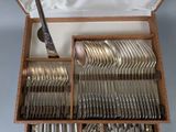 a wooden box filled with silverware and a knife