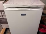 an image of a small white refrigerator in a room