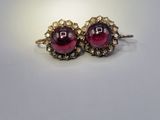 pair of garnet garnet stone earrings on a white surface