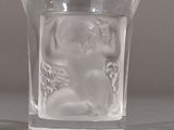 a small glass cup with a bear inside of it