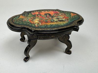 a small table with a painted design on it