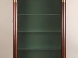 an antique wooden display cabinet with glass shelves and brass trimmings