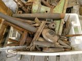 a white container filled with old tools on a wooden table