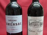 two bottles of wine sitting next to each other on a table
