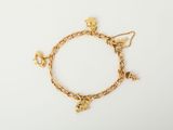 a gold bracelet with charms and charms on a white background