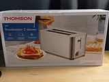 a box with a toaster and a toaster on a table