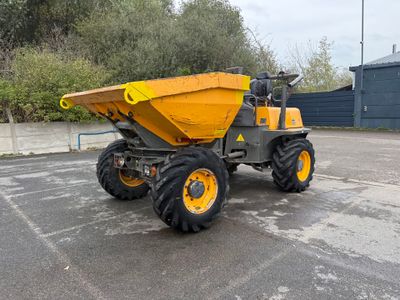 a yellow dump truck that is parked in a parking lot