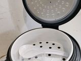 a black and white photo of a rice cooker