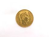 a close up of a gold coin on a white surface
