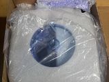 a cardboard box with a toilet in it that is wrapped in plastic