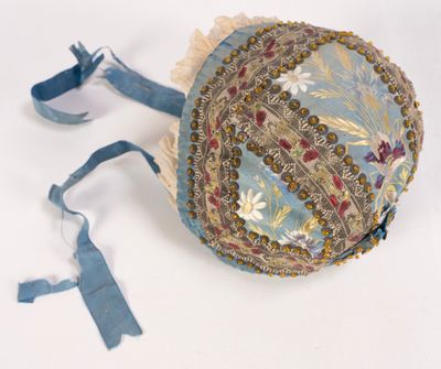 a blue hat with a floral design on it