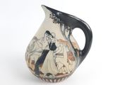 a black and white vase with a picture of a man and woman on it