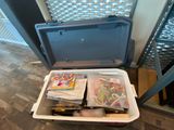 a cooler with many items in it sitting on the floor