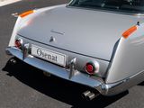 a silver car that is parked on the side of the road