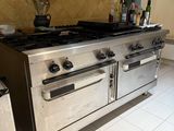 an image of a kitchen with a stove and a refrigerator